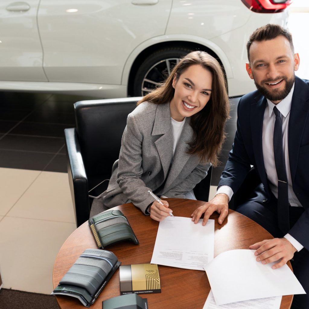 a young woman arranges a loan for a car purchase in a car dealership