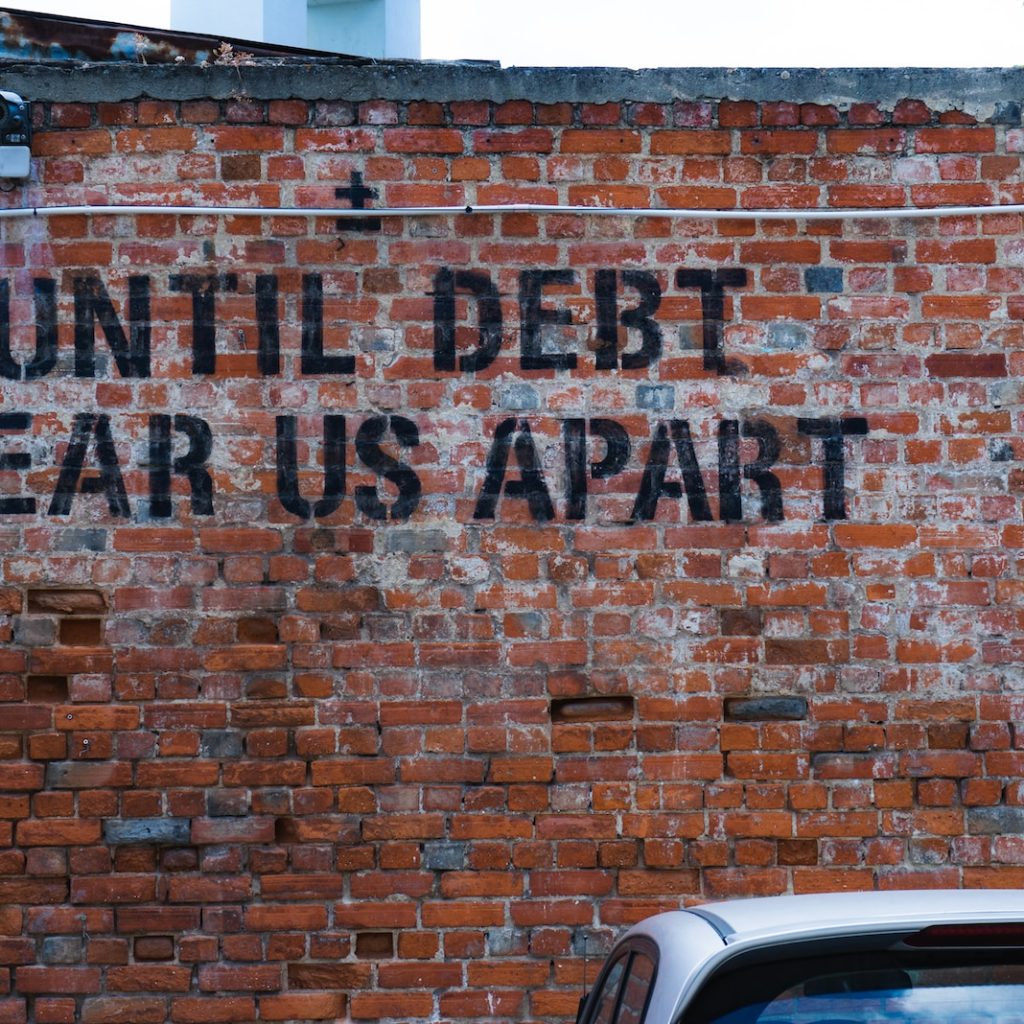 until debt tear us apart brick wall vandal