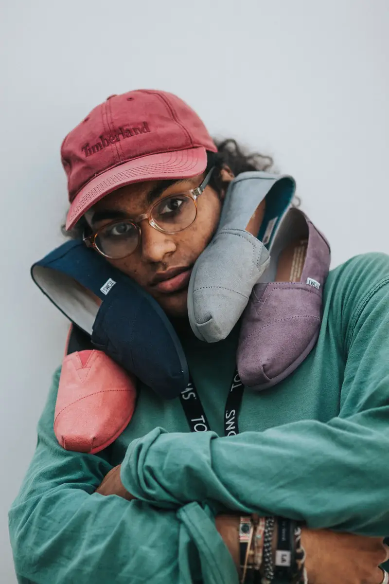 student with Toms student discount shoes on his face