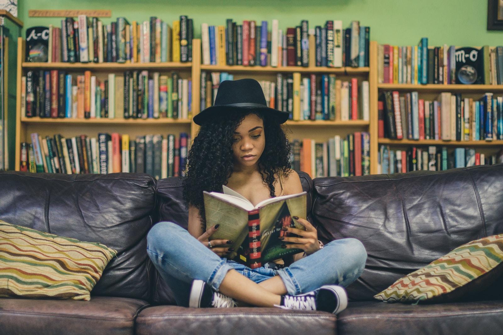 student reading book on couch