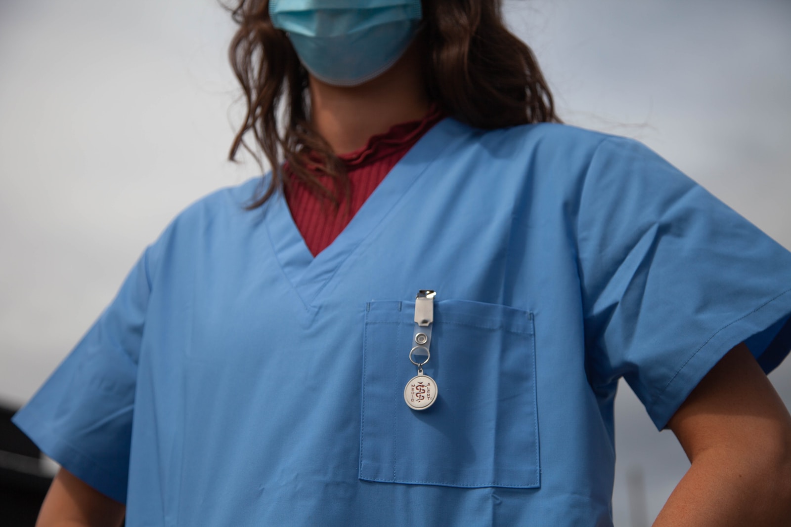 student in red shirt wearing jaanuu scrubs