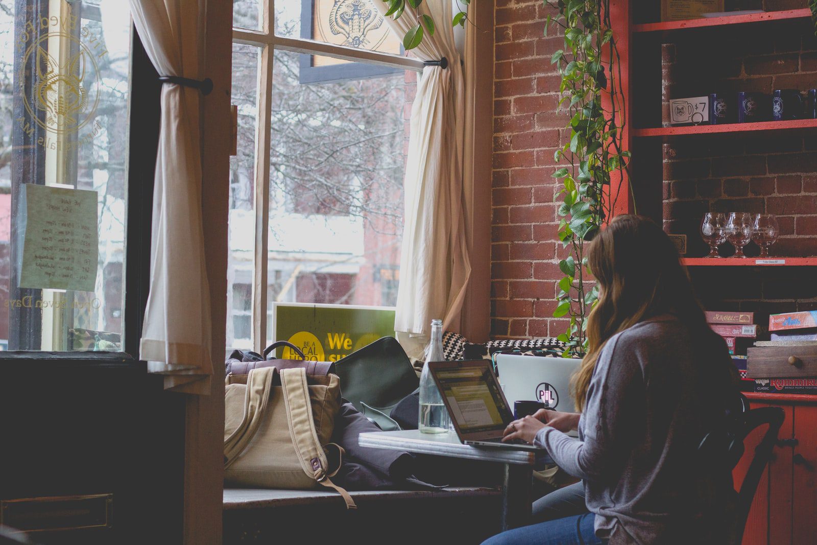 student using computer sitting on black chair