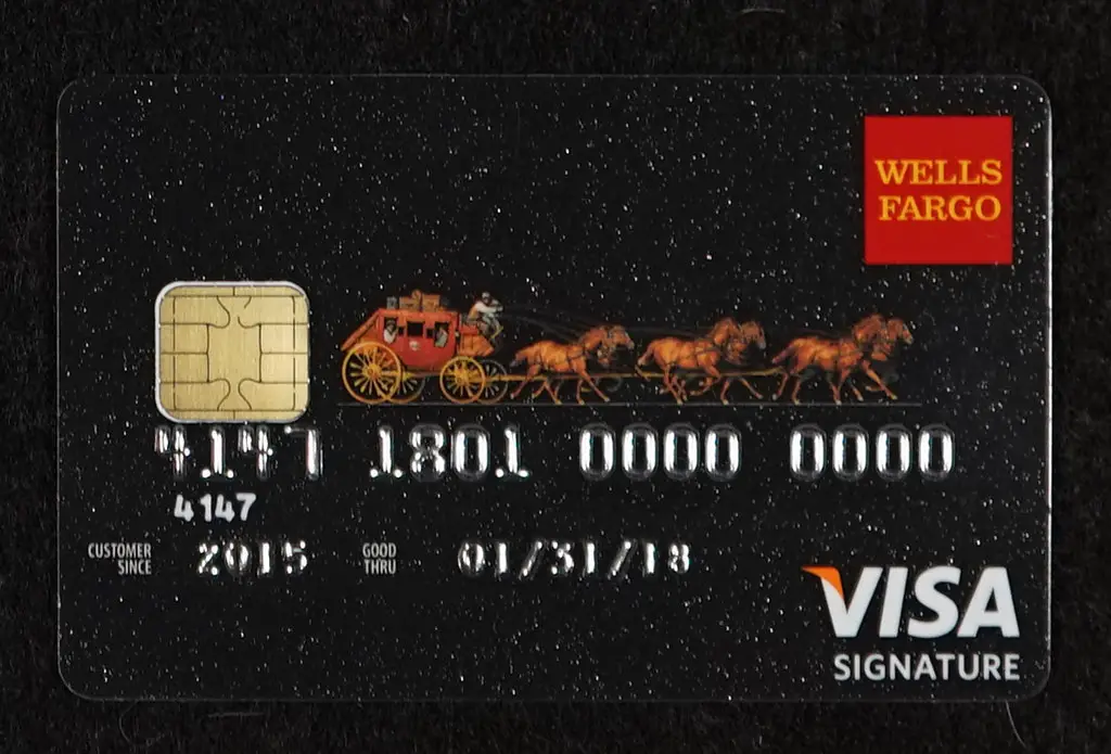 A wells fargo credit card with a horse drawn carriage.